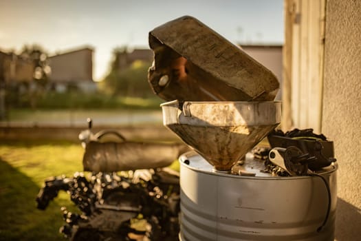 A grimy container filled with used cooking oil, captured to highlight the need for proper disposal and recycling.