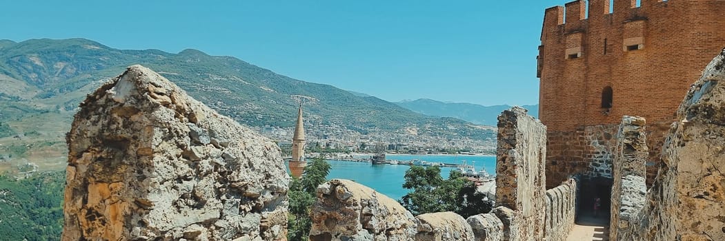 banner of view from the old fortress wall of the tower, city and sea, as well as the minarets of the mosque. Alanya Turkey. soft focus.