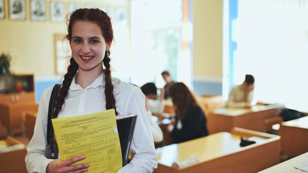 Portrait of a high school girl with notebooks