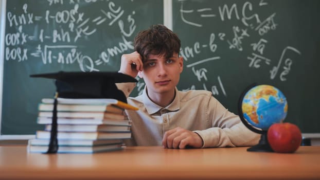 Portrait of smiling male student standing with hands in pockets in high school campus