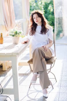 Portrait of a Russian young girl sitting on a chair