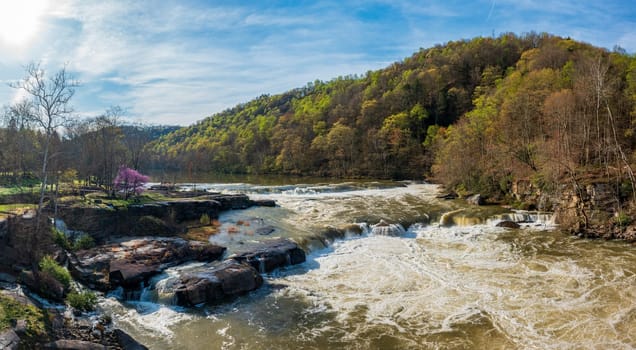 Aerial view of Valley Falls State Park near Fairmont in West Virginia on a spring day with redbud blossoms on the trees