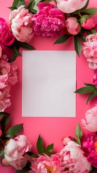 Flowers composition. Wreath made of pink peonies flowers, blank square paper sheet on pink background. Flat lay, top view, copy space. Aesthetic Valentine's Day, Mother's Day mockup template.