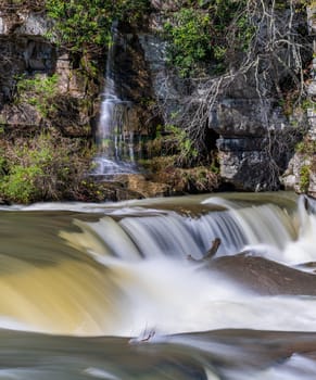 Small waterfall cascade on rocks by Valley Falls State Park near Fairmont in West Virginia on a colorful and bright spring day