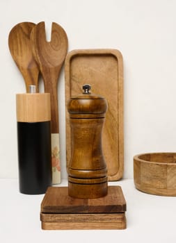 Various wooden kitchen utensils on a white background