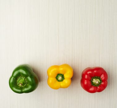 Vegetables, nutrition and bell pepper on table top for wellness, health and diet in studio. Ingredients, green and red isolated for eating, food and weight loss in house for prepare and cook