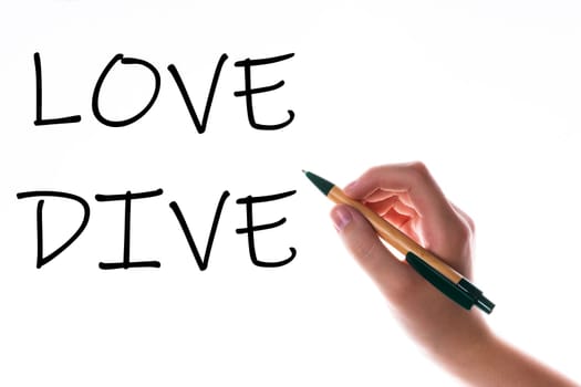 Children hand with pen write on a blue white background. Writing hand. Word Love Dive