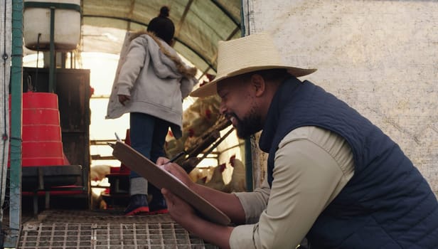Black man, farmer and writing with clipboard for cattle, inspection or counting chickens in barn. African male person taking notes with livestock or animals for agriculture or production on farm.