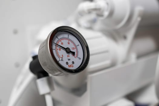 Pressure gauge shows the pressure in the reverse osmosis system.