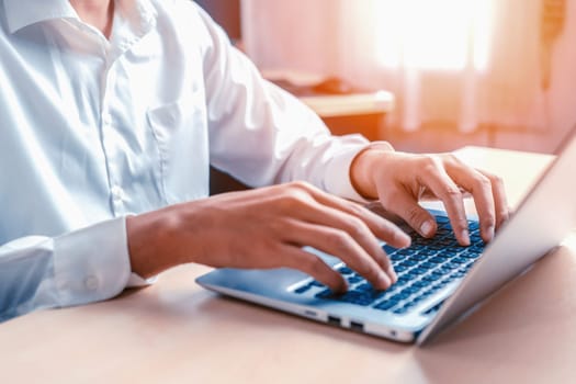 Businessman hand typing on computer keyboard of a laptop computer in office. Business and finance concept. uds