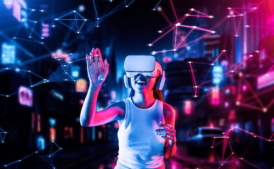 Female standing in cyberpunk style building in meta wear VR headset connecting metaverse, future cyberspace community technology, Woman trying touching virtual reality object with hand. Hallucination.