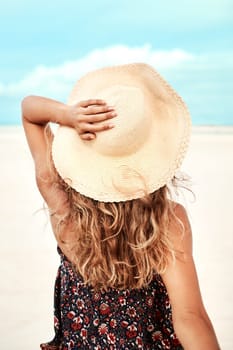 Back, beach and woman with vacation, holiday and relaxing with getaway trip and sunshine. Ibiza, rear view and girl with hat and seaside with summer and ocean with freedom and travelling with.