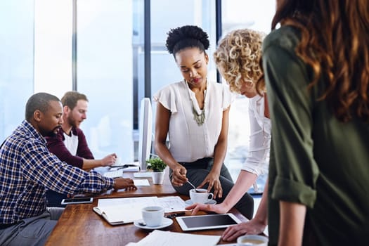 Diversity, coworkers and conversation in office with tablet, research or browse for business strategy in collaboration. Teamwork, online or web design and technology, project planning and partnership.