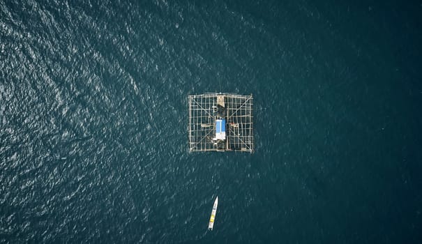 Drone, water boat in the ocean for cargo, shipping and global, ecommerce or transportation. Industry, aerial view and ship at sea for retail, distribution or freight, export fishing, food or delivery.