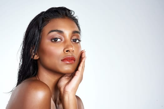 Beauty, studio and portrait of Indian woman with makeup and skincare in mockup space. Model, face and girl with confidence from healthy self care and pride from cosmetics in white background.