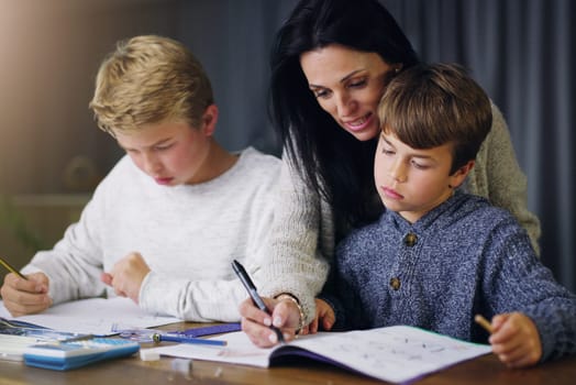Mother, children and helping with school homework in house or learning education, teaching or lesson. Woman, sons and table in apartment for student knowledge or academic studying, writing or project.