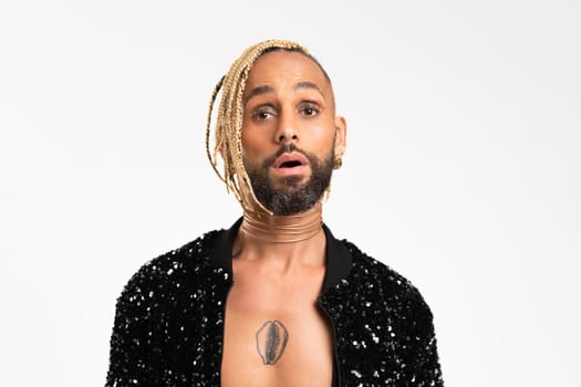 Confident black gay man with make up surprised isolated on white background, dressed black jacket with sequins. Exudes sense of pride and individuality. Diversity power of personal style