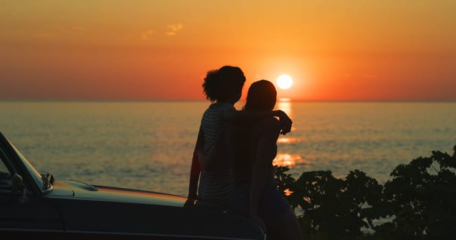 Sunset, hug and beach with couple, car and travel with adventure, vacation and getaway trip. Silhouette, people and ocean with summer, outdoor or nature with view and romance with vehicle and holiday.