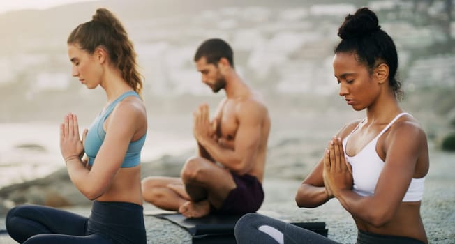 Man, women and meditation on beach for zen peace in morning mist, mindfulness or healing. Friends, hands and wellness chakra for self care or holistic yogi as group for balance, calm or environment.