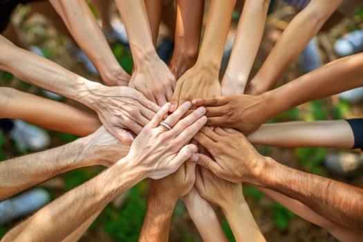 A group of people are holding hands in a circle.