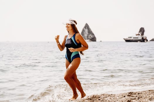 Woman beach vacation photo. A happy tourist in a blue bikini enjoying the scenic view of the sea and volcanic mountains while taking pictures to capture the memories of her travel adventure