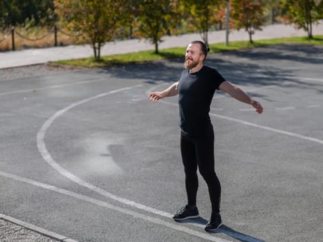 Bearded man doing exercises outdoors