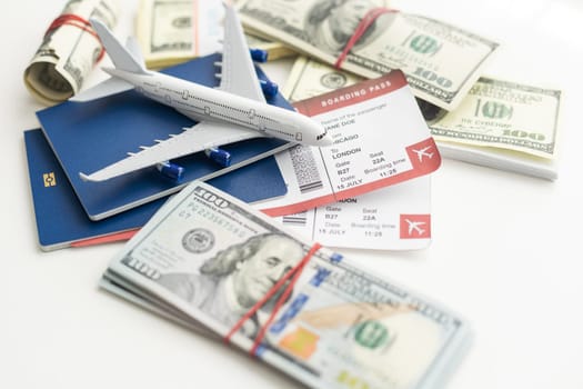 Airplane and money. Plane on the background of USA dollars. The cost of travel, air tickets and flights, financial expenses for vacation. High quality photo