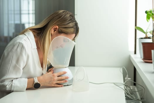 Beautician holding ultrasound device for face and skin lifting procedure and hair removal. Young woman cosmetologist using modern cosmetology equipment in clinic. High quality photo