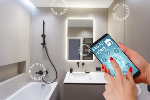 Female hands holding phone with app smart home screen in room house.