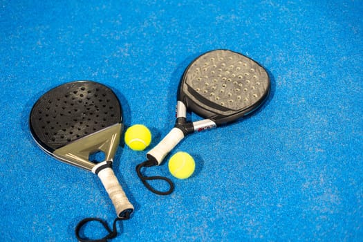 Padel tennis racket. Background with copy space. Sport court and balls. High quality photo