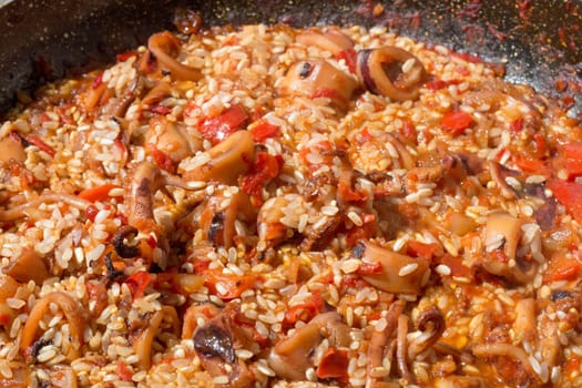 Witness the pivotal moment as rice joins the aromatic sofrito, enhancing the essence of traditional Spanish paella