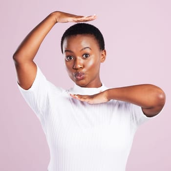 Black woman, portrait and frame hand sign with box, vogue and fun gesture in a studio. Kiss, funny and happy with modern and casual fashion with pink background and silly with minimalist fashion.