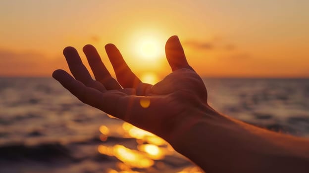 A person's hand reaching out to the sun as it sets