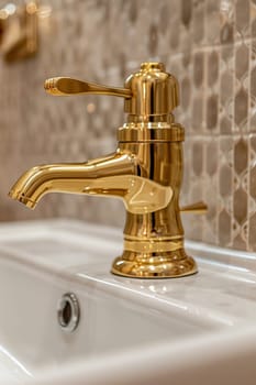A close up of a gold faucet on the sink in front