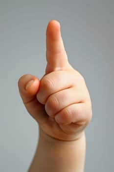 A close up of a child pointing at something with their finger
