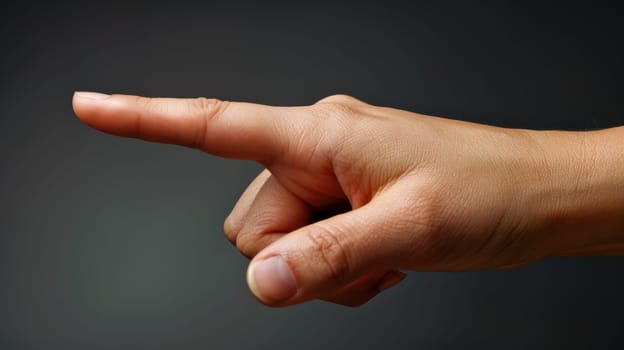 A close up of a hand pointing at something with its finger