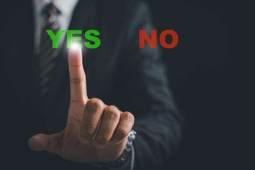 Close-up of a businessman finger pressing the Yes button, signifying decisive action and choice affirmation. Technology and decision-making concept. Think With Yes Or No Choice.