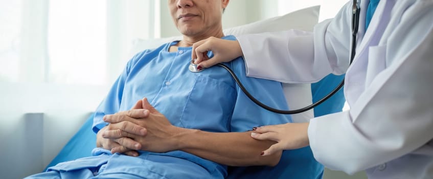 A female doctor gives a health examination consultation and explains the details of health care to a patient in the clinic..