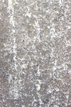 The surface of an old, time-damaged stone wall, gray, close up. Stone plate.