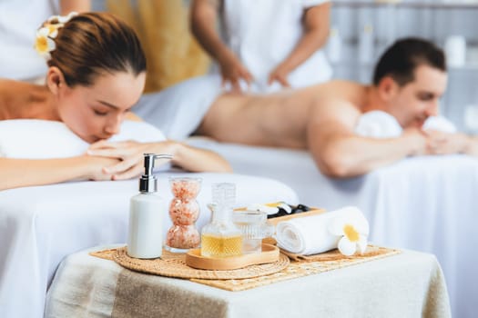 Aromatherapy massage on daylight ambiance or spa salon composition setup with focus decor and spa accessories on blur woman enjoying blissful aroma spa massage in resort or hotel background. Quiescent