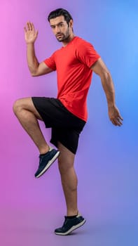 Full body length gaiety shot athletic and sporty young man fitness running cardio exercise posture on isolated background. Healthy active and body care lifestyle.