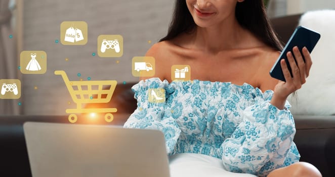 Elegant customer wearing blue dress controlling device choosing online platform. Smart consumer watching gadget opening e-commerce application using cashless technology shopping inventory. Cybercash.