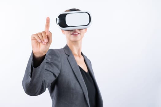 Professional female leader touching at program or working while using VR glasses. Skilled businesswoman pointing at system while connecting at metaverse by wearing visual reality goggles. Contraption.