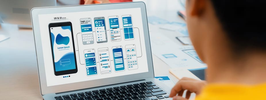 Panorama banner of startup UX developer or company employee design user interface or UI prototype for mobile application or website software with software display on laptop monitor in office. Synergic