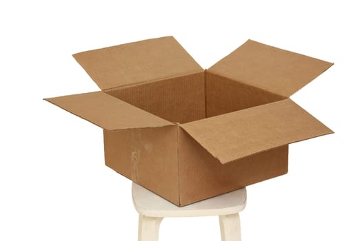 Rectangle cardboard box on beige stool for creative arts and toy storage.