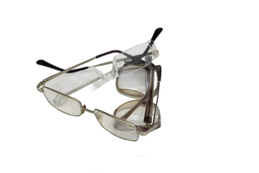 Three different glasses lie on top of each other isolated on white background.