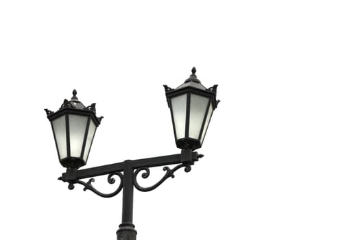 Street light with dual lanterns illuminating the night against a white backdrop.