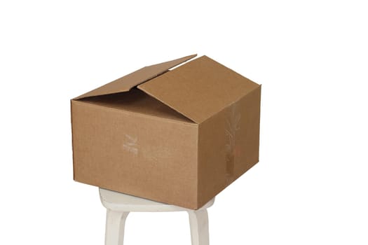 Rectangle cardboard box on beige stool for creative arts and toy storage.