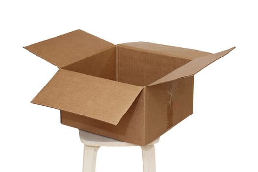 Rectangle cardboard box on beige stool for creative arts and toy storage.