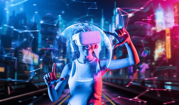 Female stand in cyberpunk style building in meta wear VR headset connecting metaverse, future cyberspace community technology, Woman use thumb and index fingers focus 3d hologram globe. Hallucination.